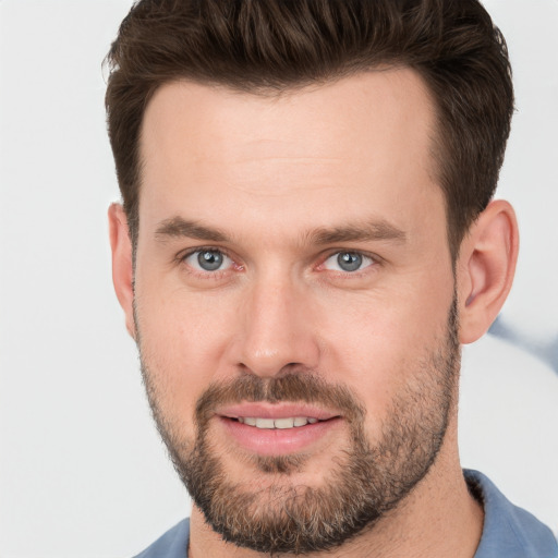 Joyful white young-adult male with short  brown hair and brown eyes