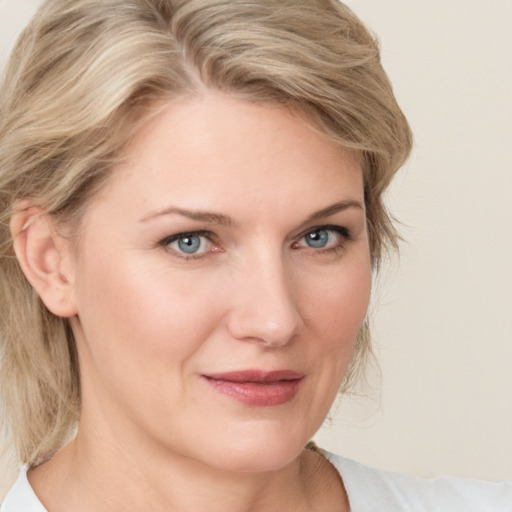 Joyful white young-adult female with medium  blond hair and blue eyes