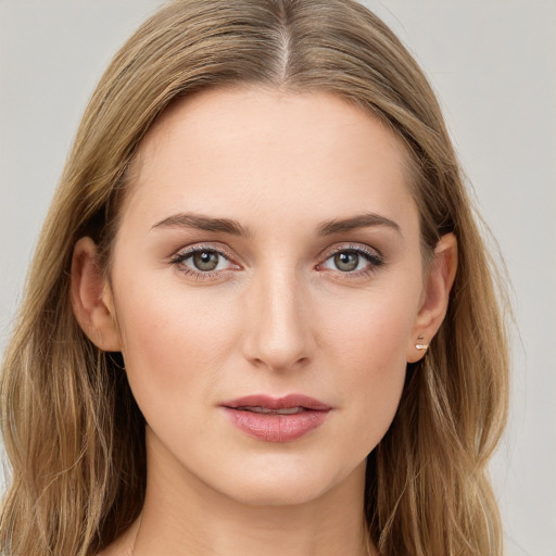 Joyful white young-adult female with long  brown hair and green eyes