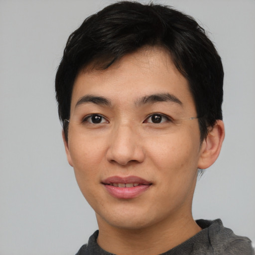 Joyful asian young-adult male with short  black hair and brown eyes