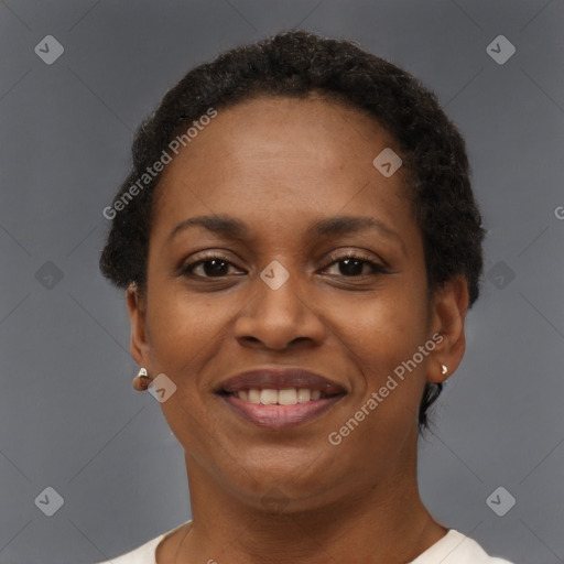 Joyful black adult female with short  brown hair and brown eyes