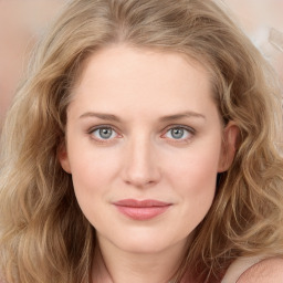 Joyful white young-adult female with long  brown hair and blue eyes