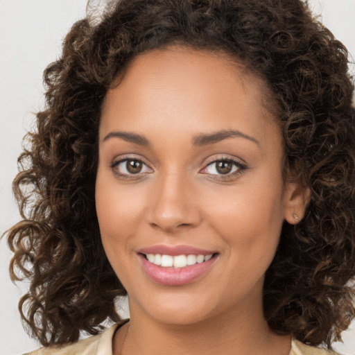 Joyful white young-adult female with long  brown hair and brown eyes