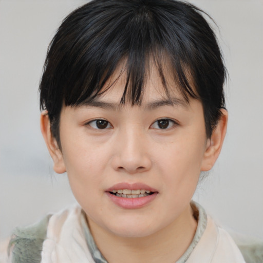 Joyful asian child female with medium  brown hair and brown eyes