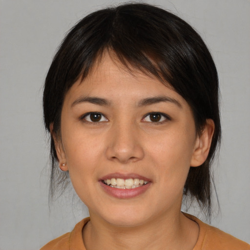 Joyful asian young-adult female with medium  brown hair and brown eyes