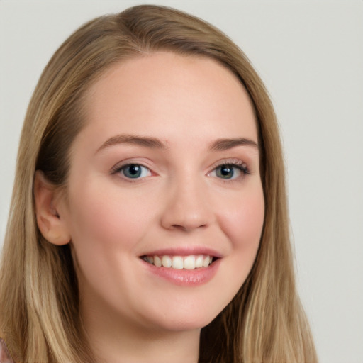 Joyful white young-adult female with long  brown hair and blue eyes