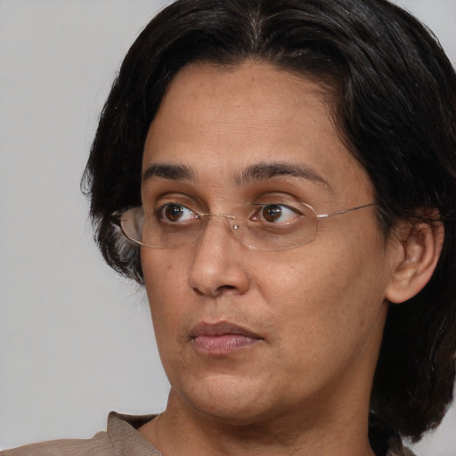 Joyful asian adult female with medium  brown hair and brown eyes