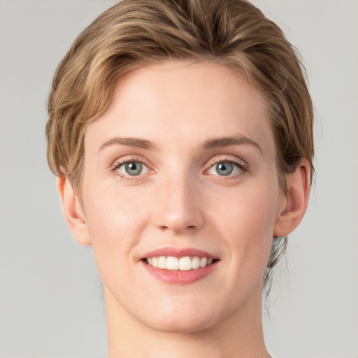 Joyful white young-adult female with medium  brown hair and green eyes