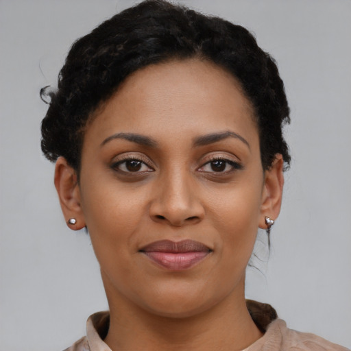 Joyful black young-adult female with short  brown hair and brown eyes