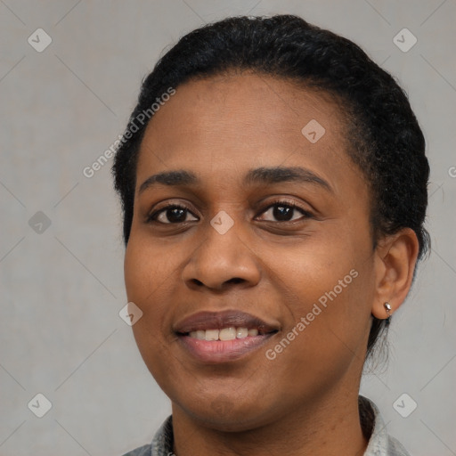 Joyful black young-adult female with short  black hair and brown eyes