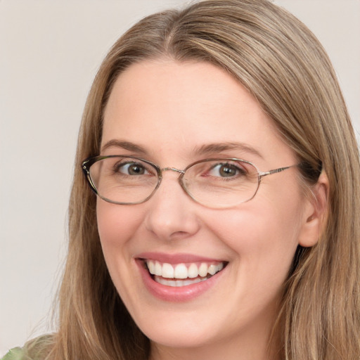 Joyful white young-adult female with long  brown hair and green eyes