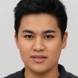 Joyful asian young-adult male with short  black hair and brown eyes