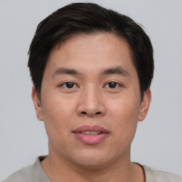 Neutral asian young-adult male with short  brown hair and brown eyes