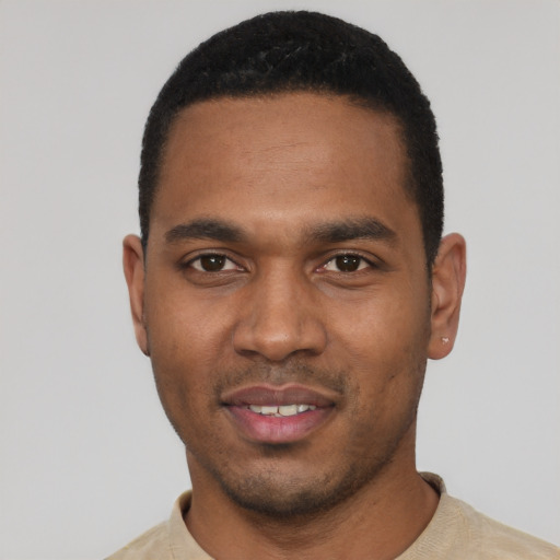 Joyful black young-adult male with short  black hair and brown eyes
