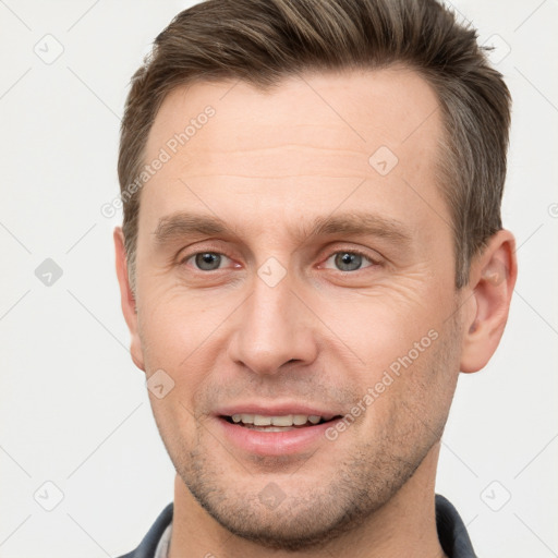 Joyful white adult male with short  brown hair and grey eyes