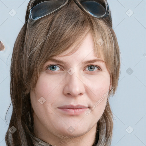 Joyful white young-adult female with long  brown hair and blue eyes