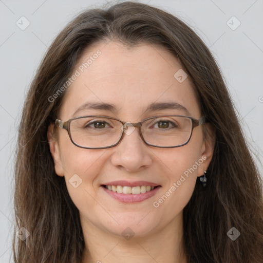 Joyful white adult female with long  brown hair and grey eyes