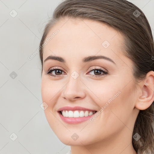 Joyful white young-adult female with long  brown hair and brown eyes