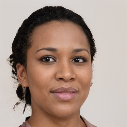 Joyful black young-adult female with medium  black hair and brown eyes
