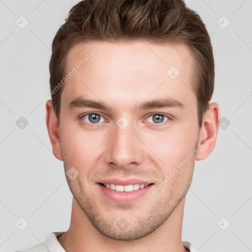 Joyful white young-adult male with short  brown hair and grey eyes