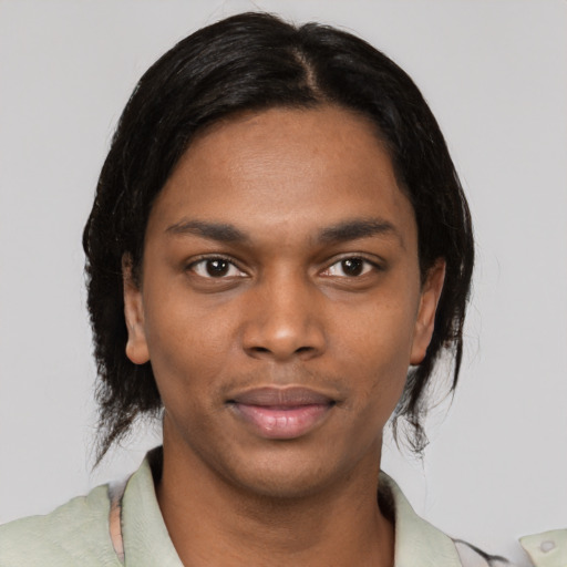 Joyful black young-adult male with medium  black hair and brown eyes