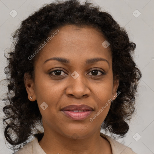 Joyful black adult female with medium  brown hair and brown eyes