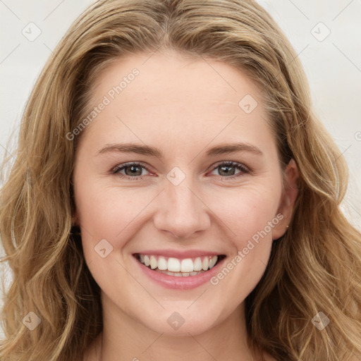 Joyful white young-adult female with long  brown hair and green eyes