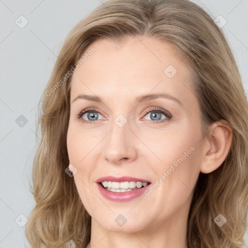 Joyful white young-adult female with long  brown hair and blue eyes