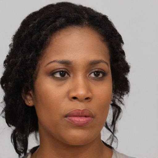 Neutral black young-adult female with medium  brown hair and brown eyes
