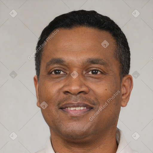 Joyful black adult male with short  black hair and brown eyes
