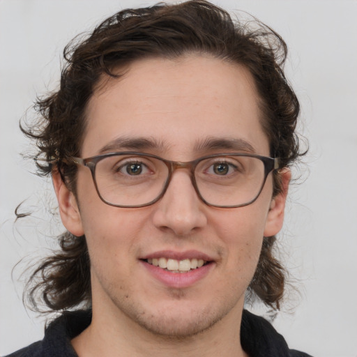 Joyful white adult male with medium  brown hair and brown eyes