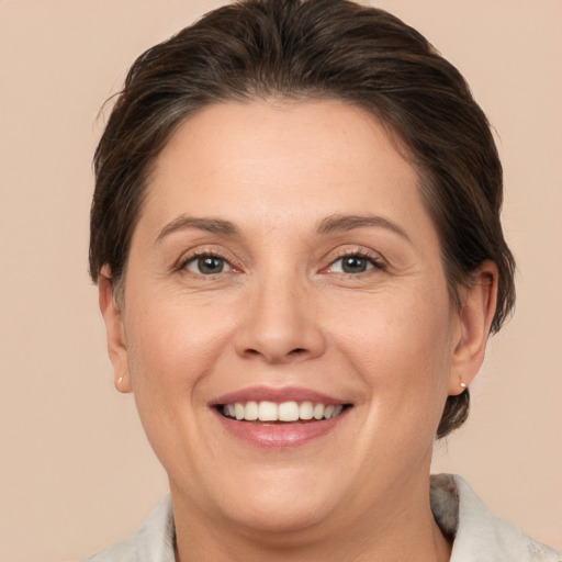 Joyful white adult female with short  brown hair and grey eyes