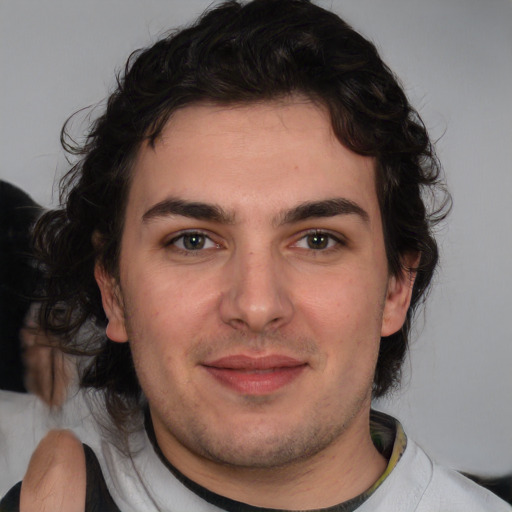 Joyful white young-adult male with medium  brown hair and brown eyes