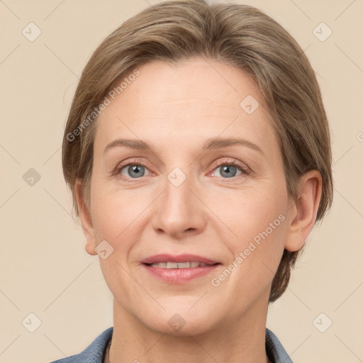 Joyful white adult female with medium  brown hair and grey eyes