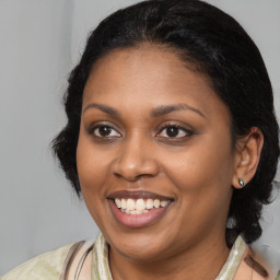 Joyful black young-adult female with medium  brown hair and brown eyes