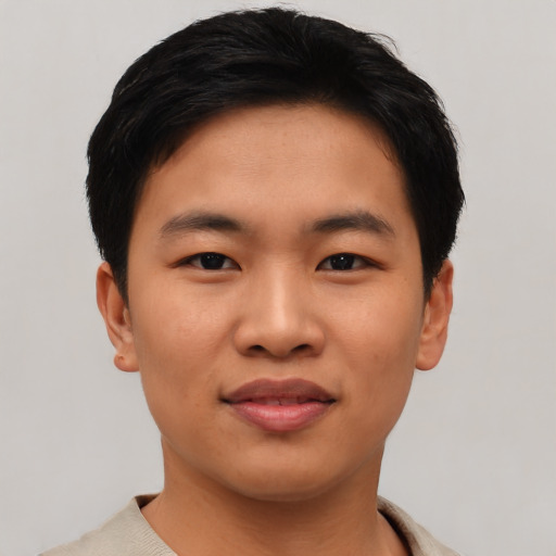 Joyful asian young-adult male with short  black hair and brown eyes