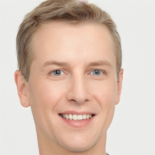 Joyful white adult male with short  brown hair and grey eyes