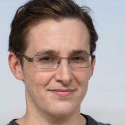 Joyful white adult male with short  brown hair and grey eyes