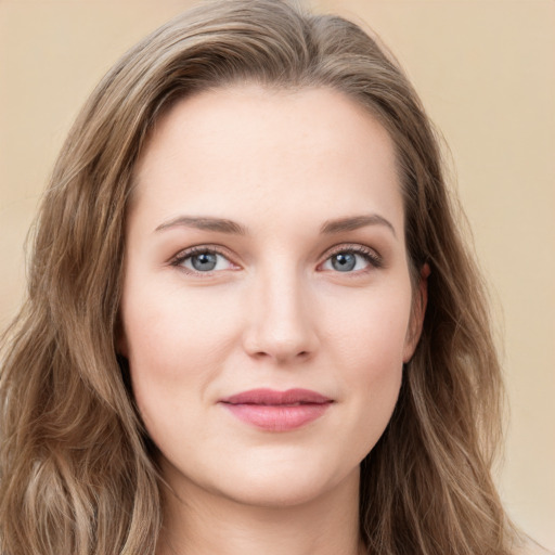 Joyful white young-adult female with long  brown hair and green eyes