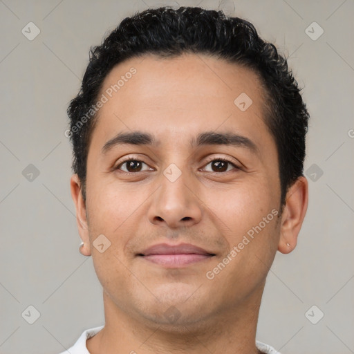 Joyful latino young-adult male with short  brown hair and brown eyes