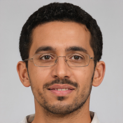 Joyful latino young-adult male with short  brown hair and brown eyes