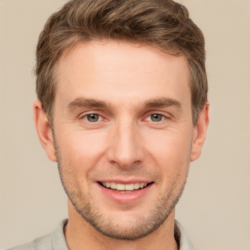 Joyful white young-adult male with short  brown hair and brown eyes