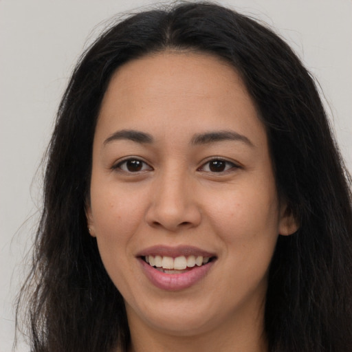 Joyful asian young-adult female with long  brown hair and brown eyes