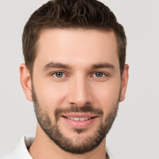 Joyful white young-adult male with short  brown hair and brown eyes