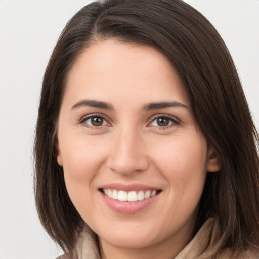 Joyful white young-adult female with long  brown hair and brown eyes