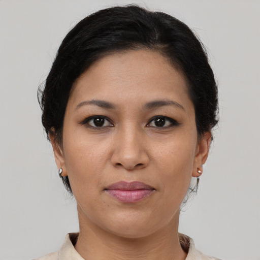 Joyful latino young-adult female with short  brown hair and brown eyes