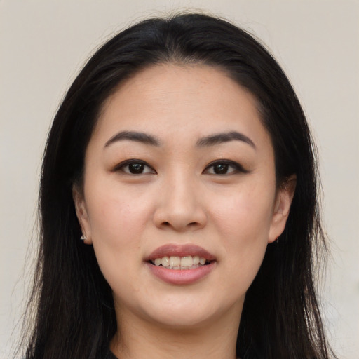 Joyful asian young-adult female with long  black hair and brown eyes