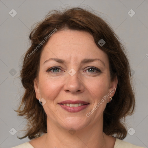 Joyful white adult female with medium  brown hair and brown eyes