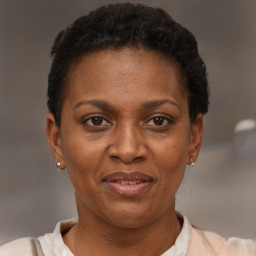 Joyful black adult female with short  brown hair and brown eyes