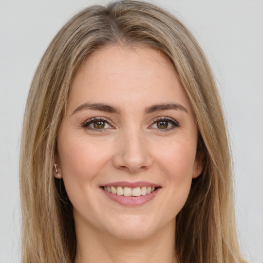 Joyful white young-adult female with long  brown hair and green eyes